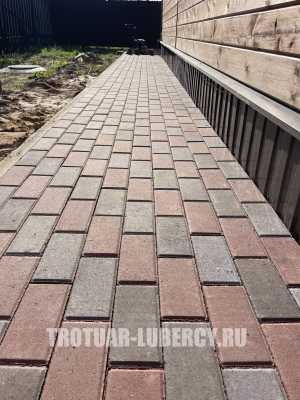 уложенная дорожка из тротуарной плитки брусчатка
